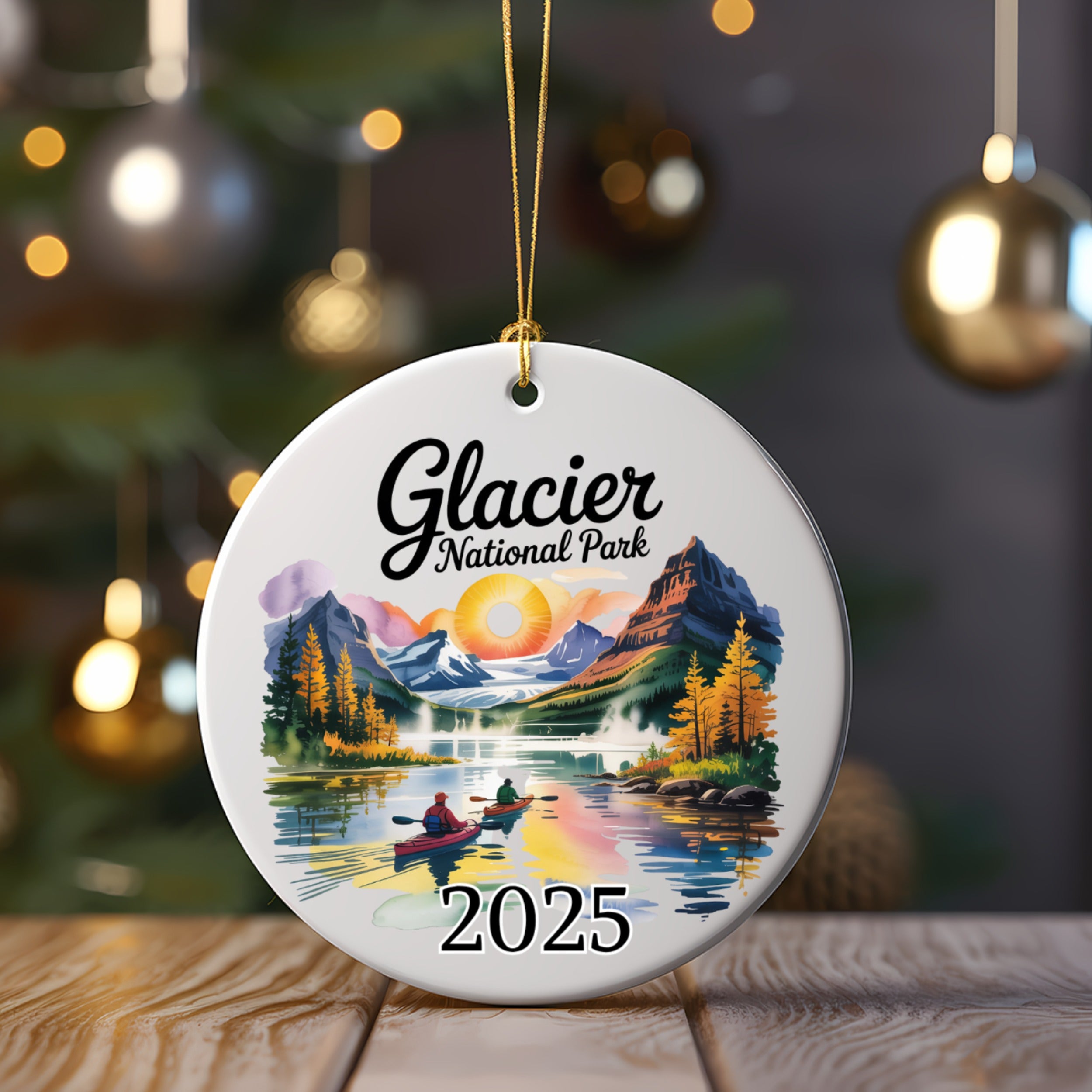 Glacier National Park 2025 ornament with kayakers on a lake and mountains.