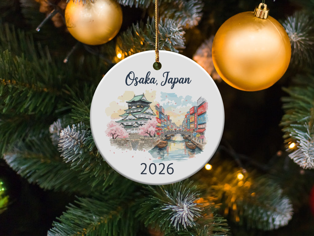 White ornament with Osaka Castle, canal, and "Osaka, Japan 2026" text.