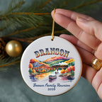 Round ceramic ornament with "Branson Brown Family Reunion 2026" and autumn scene.