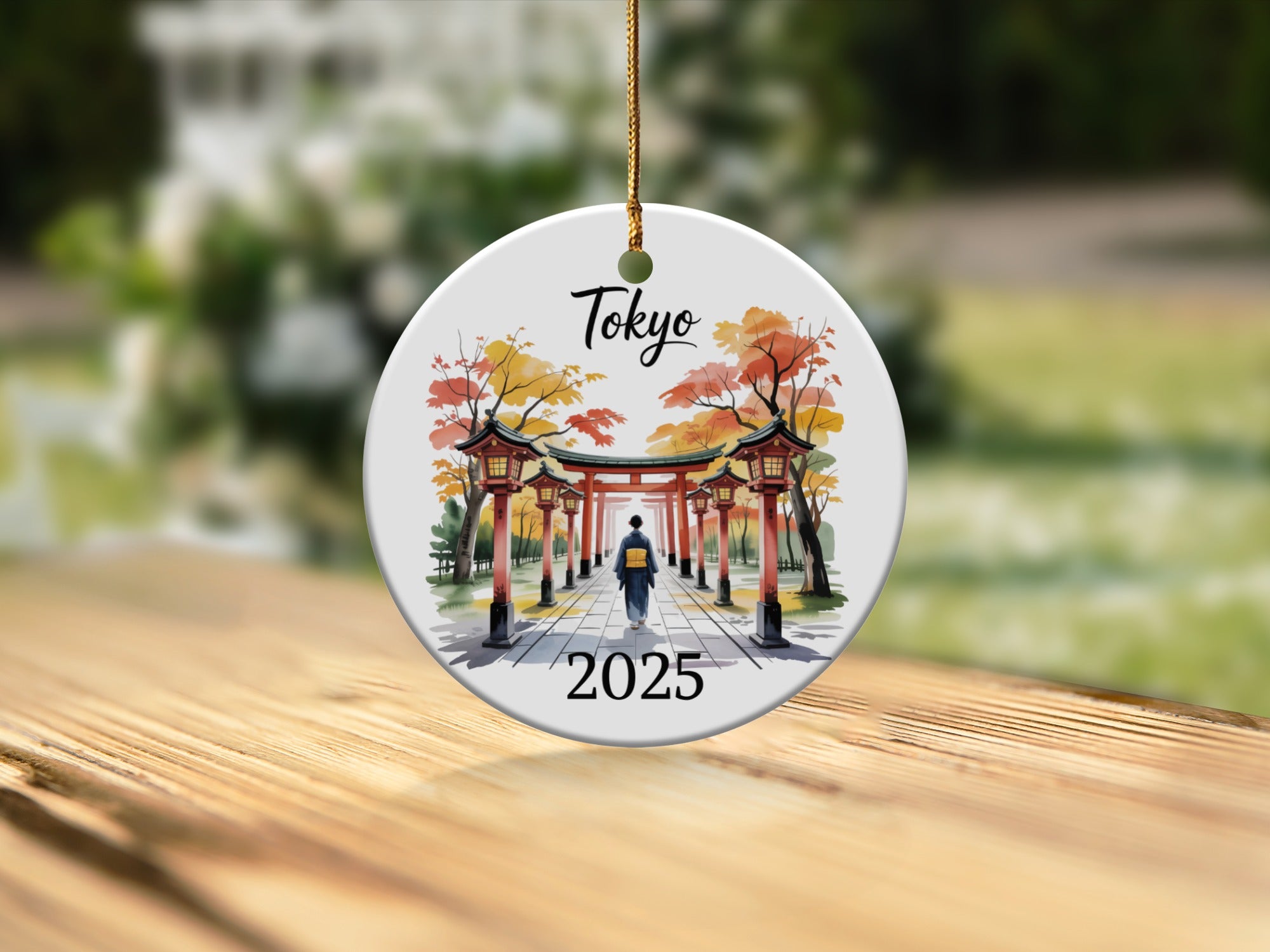 Round ornament featuring a Japanese torii gate and temple with Tokyo 2025 text.