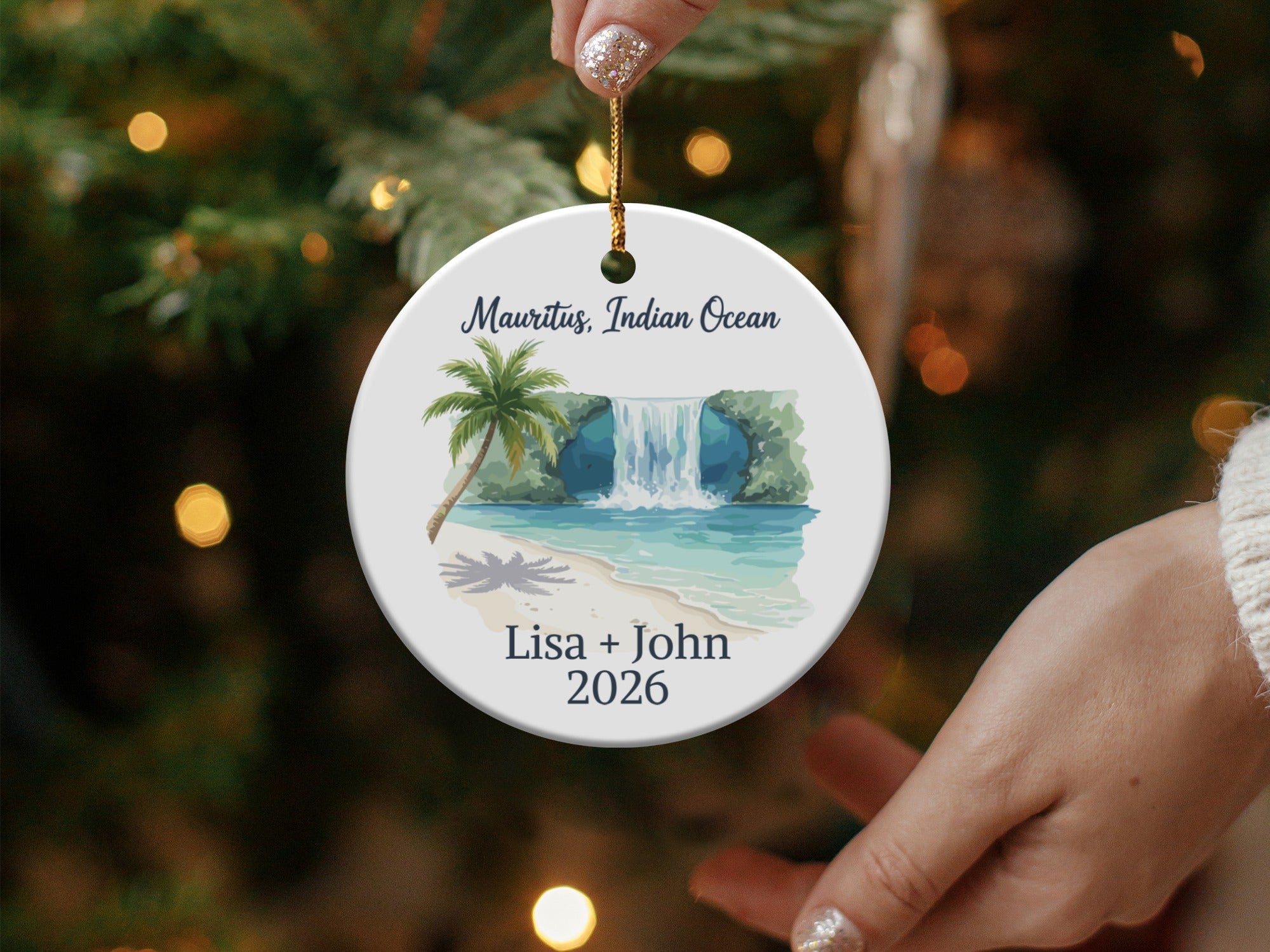 Round ornament with waterfall scene, text "Mauritius, Indian Ocean Lisa + John 2026".