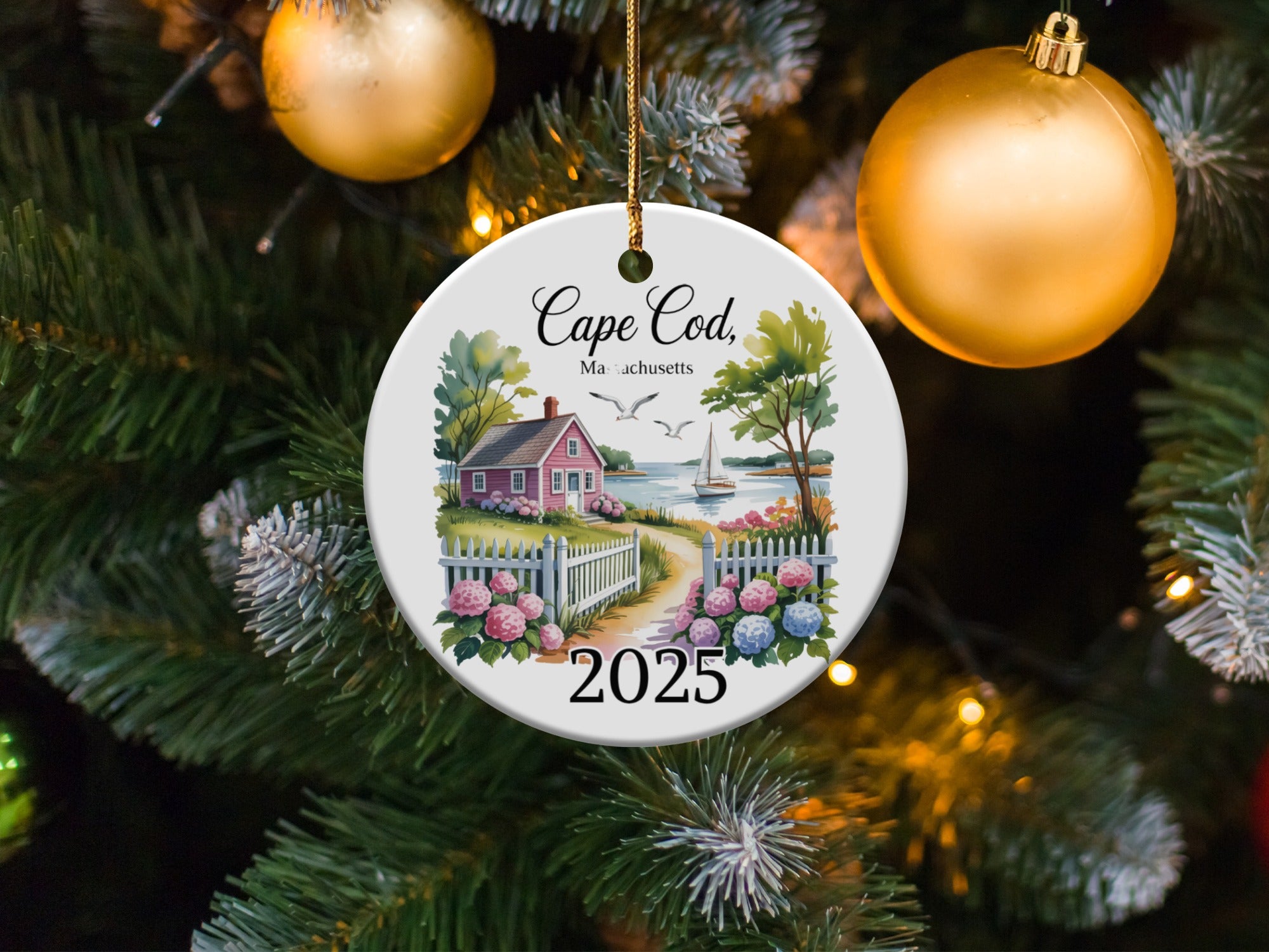 Cape Cod Massachusetts 2025 ceramic ornament with house, fence, and ocean view.