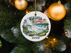 Niagara Falls ornament with rainbow, "2026" text, hanging on a Christmas tree.
