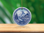 Round Swiss ornament depicting Matterhorn, lake, village, and text "Switzerland".