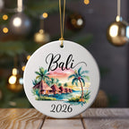 Round Bali 2026 ornament with tropical huts and palm trees.