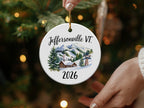Round ceramic ornament with "Jeffersonville VT 2026" and ski village scene.