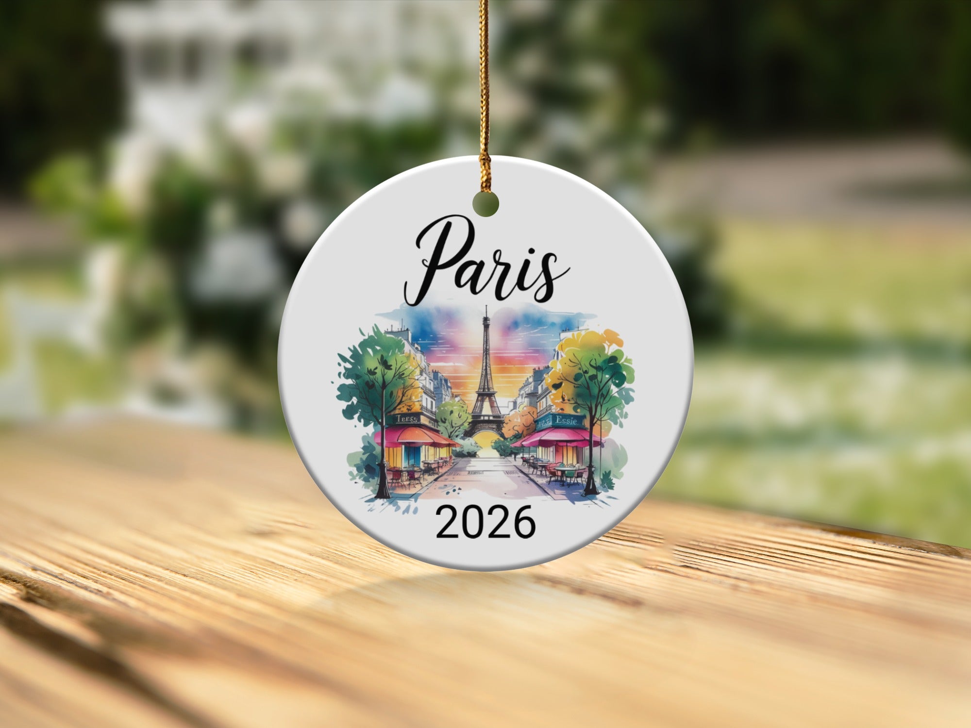 Round ornament with "Paris 2026" and a watercolor street scene.
