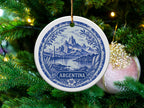 Round ceramic ornament with blue and white scenic design and "ARGENTINA" text.
