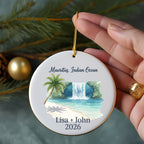 Round ornament with waterfall scene, palm tree, beach, "Mauritius, Indian Ocean Lisa + John 2026."