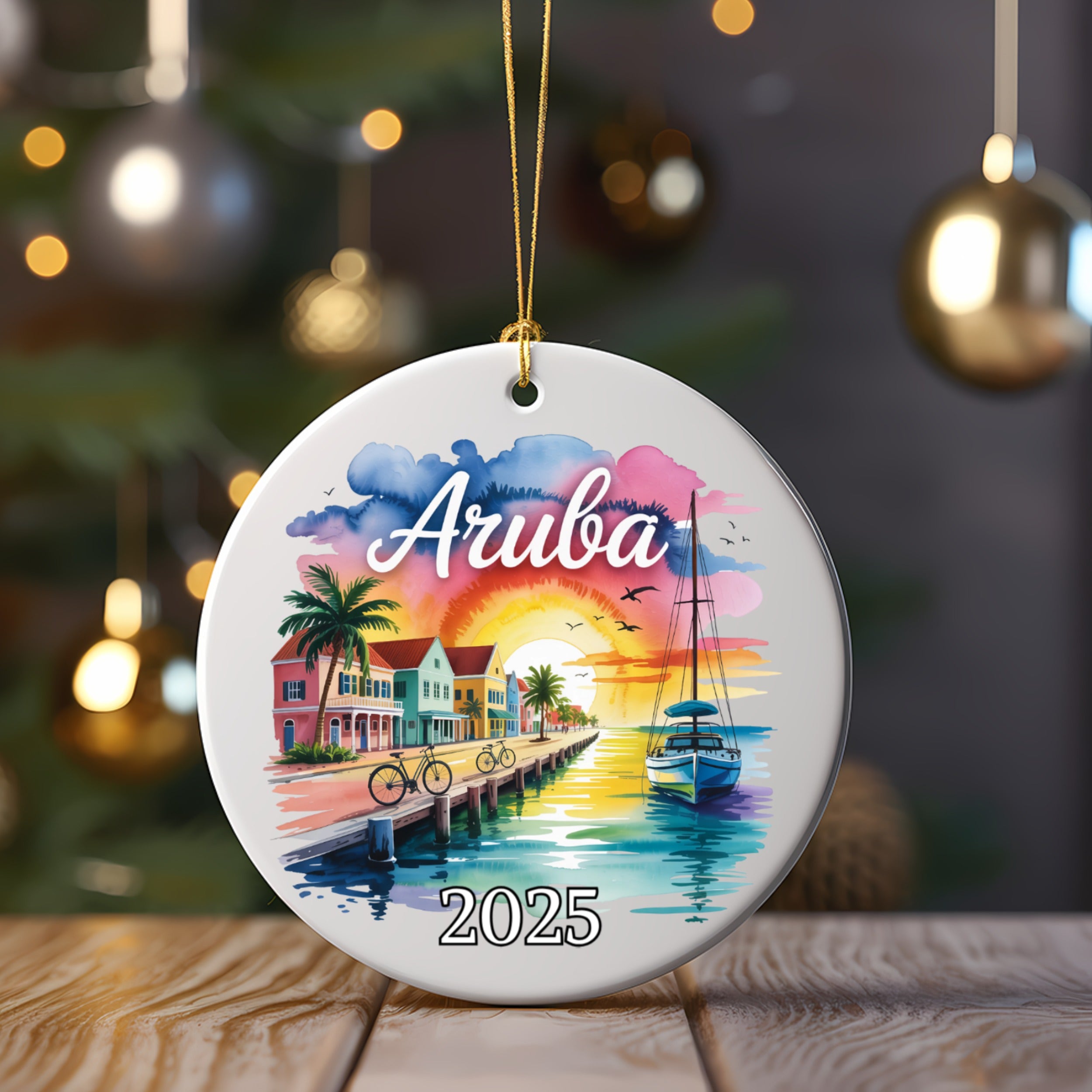 Round ceramic ornament with "Aruba 2025" and a coastal sunset scene.