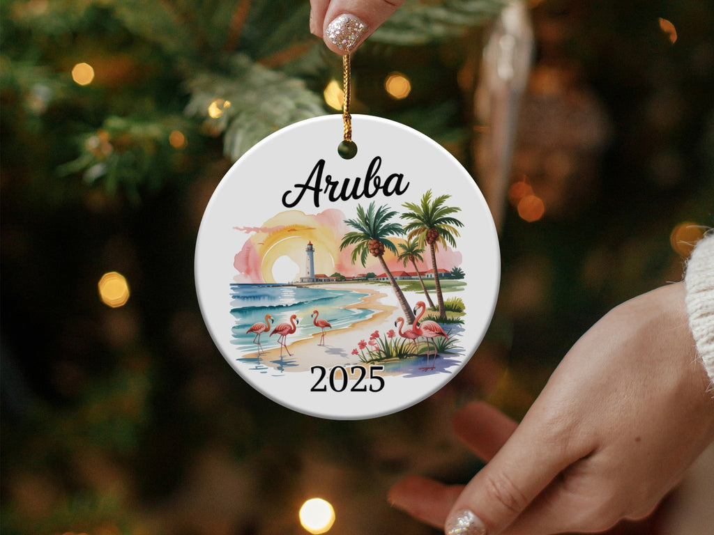 Round Aruba ornament with flamingos and palm trees, dated 2025.