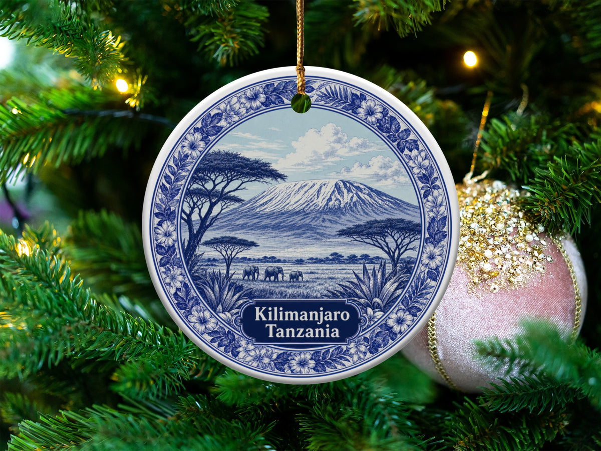 Round ornament featuring Kilimanjaro, Tanzania landscape with elephants, hanging on a Christmas tree.
