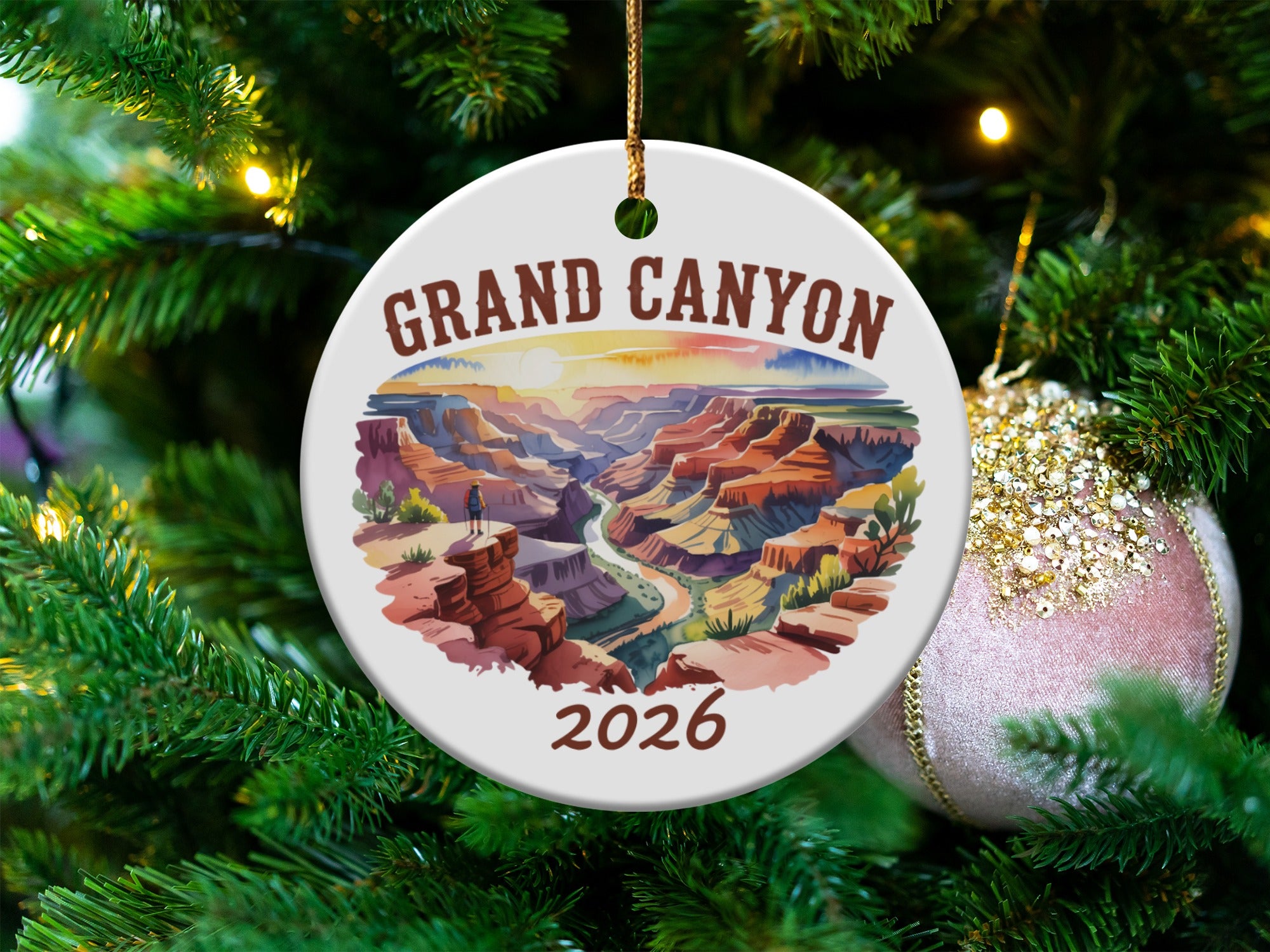 Grand Canyon ceramic ornament with date 2026 hangs on a Christmas tree.