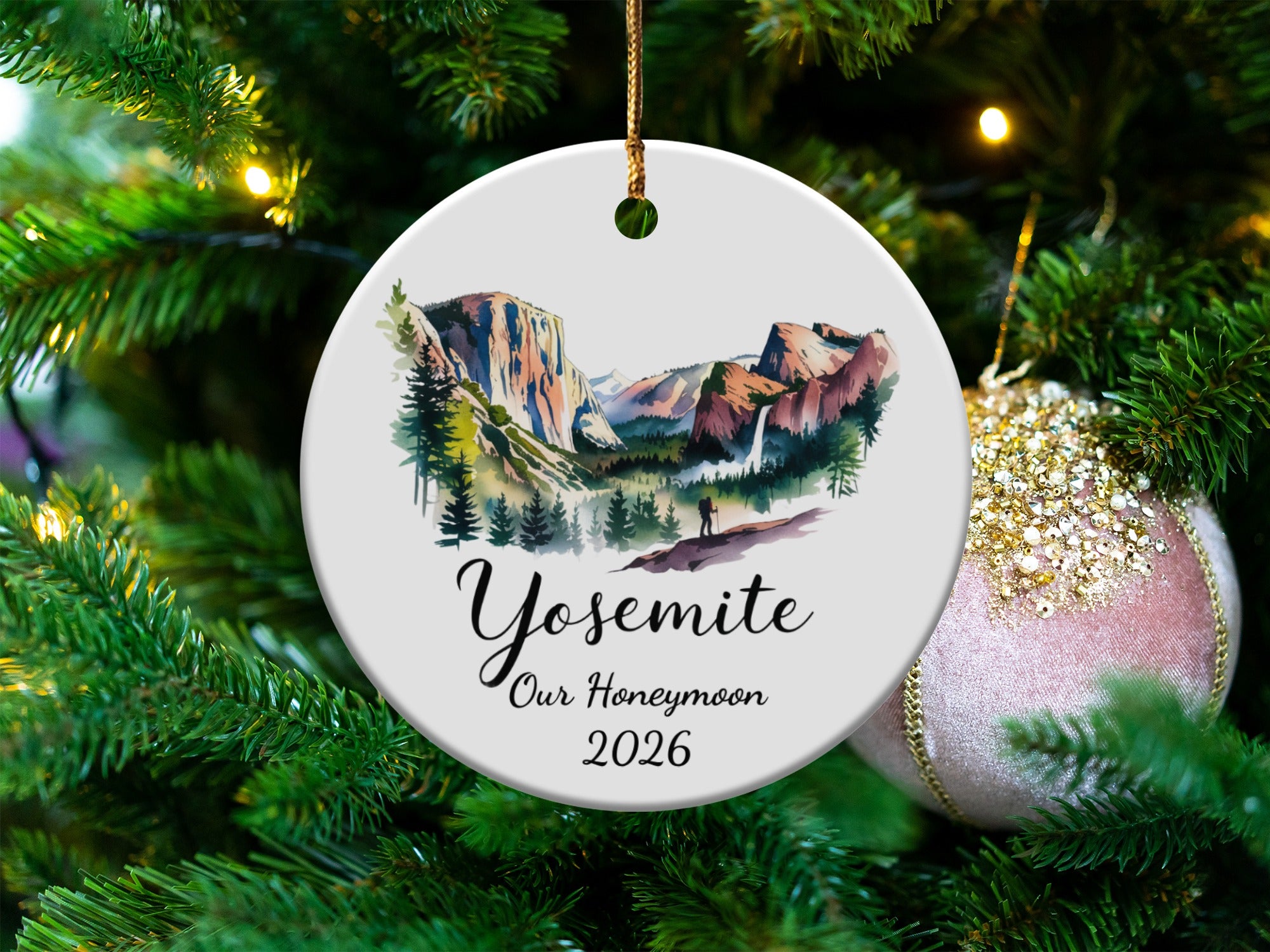 Round ceramic ornament with Yosemite National Park watercolor scene and text.