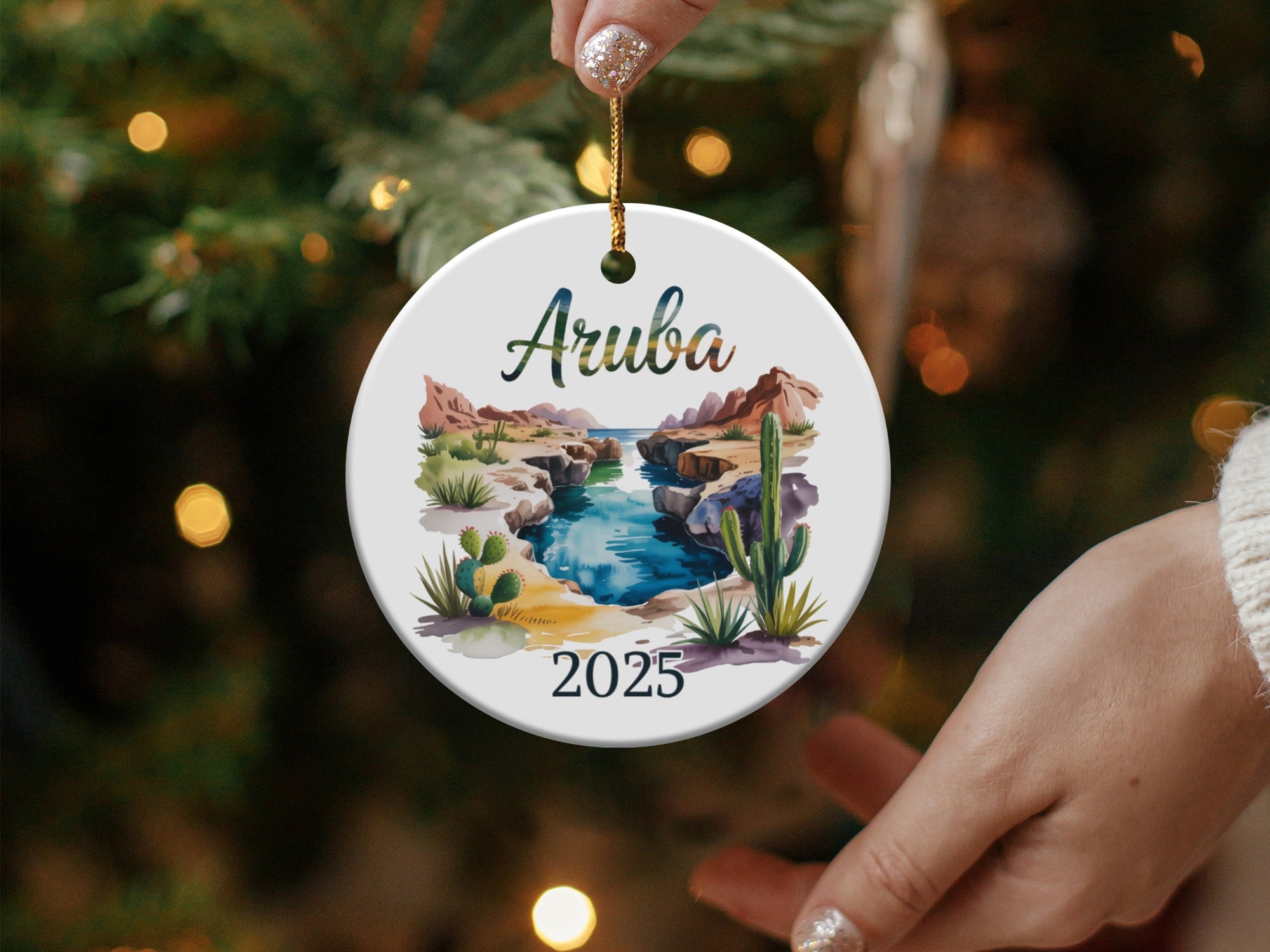 Round ornament with a watercolor landscape of Aruba and "2025" text.