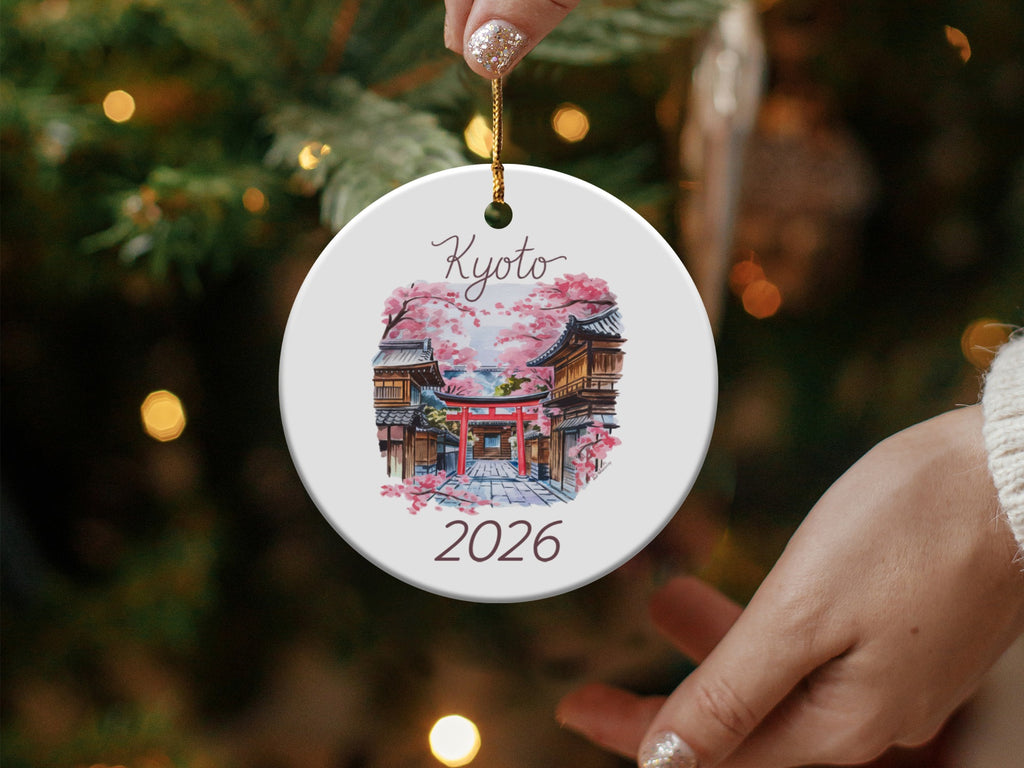 Round ceramic ornament with Kyoto temple, cherry blossoms, and 2026.